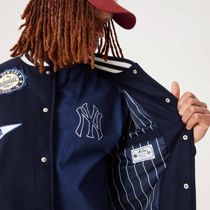 New Era Heritage marineblauw varsity-jack met all-over patch BT242564